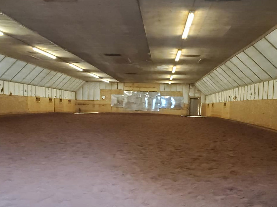 An inside view of the indoor riding arena