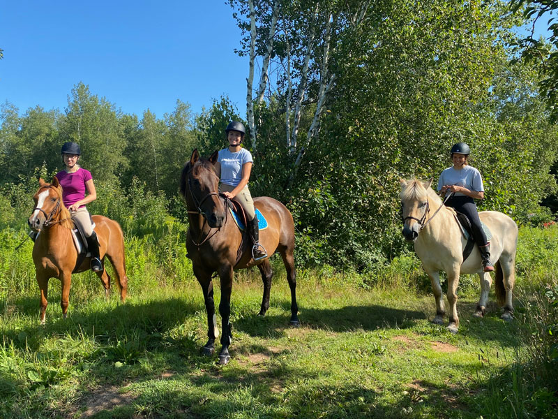 Three riders enjoy a trail ride at Willow and Withers Stables
