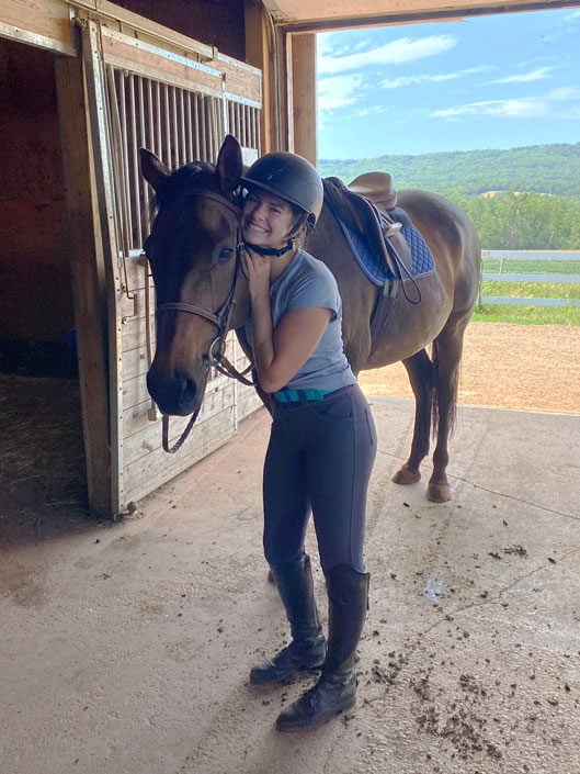 Happy rider shares a moment with her horse at Willow and Withers Stables