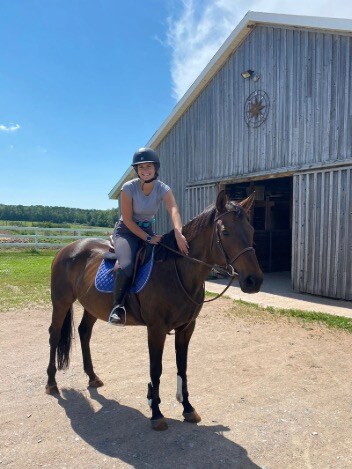 Horse gets a gentle pat from her rider